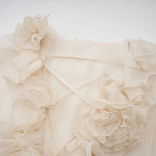 Close-up of a beige fabric with ruffled texture on a light background