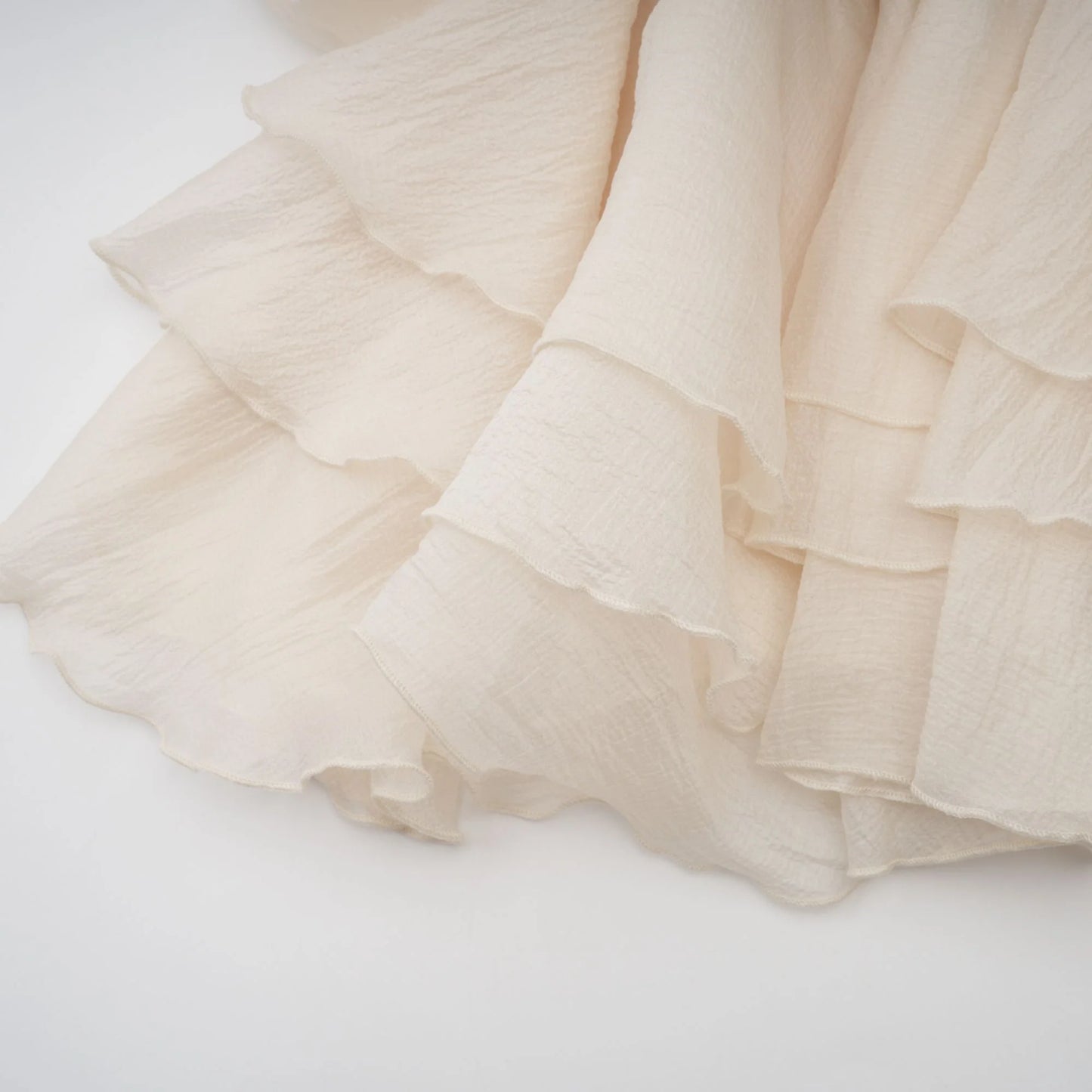 Beige ruffled fabric on a white background