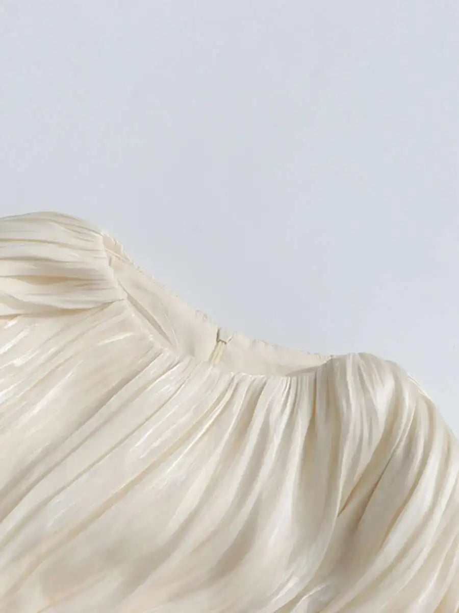 Close-up of a beige strapless dress on a white background