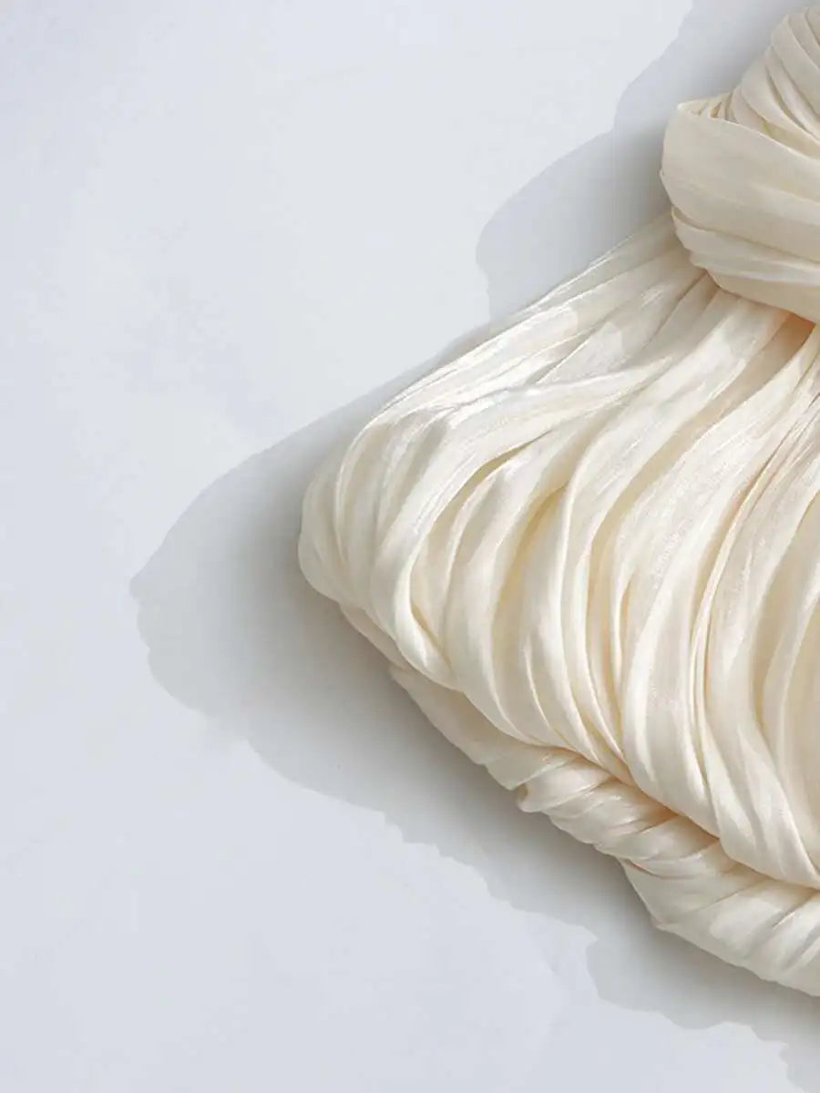 Close-up of beige ruffled fabric on a white background